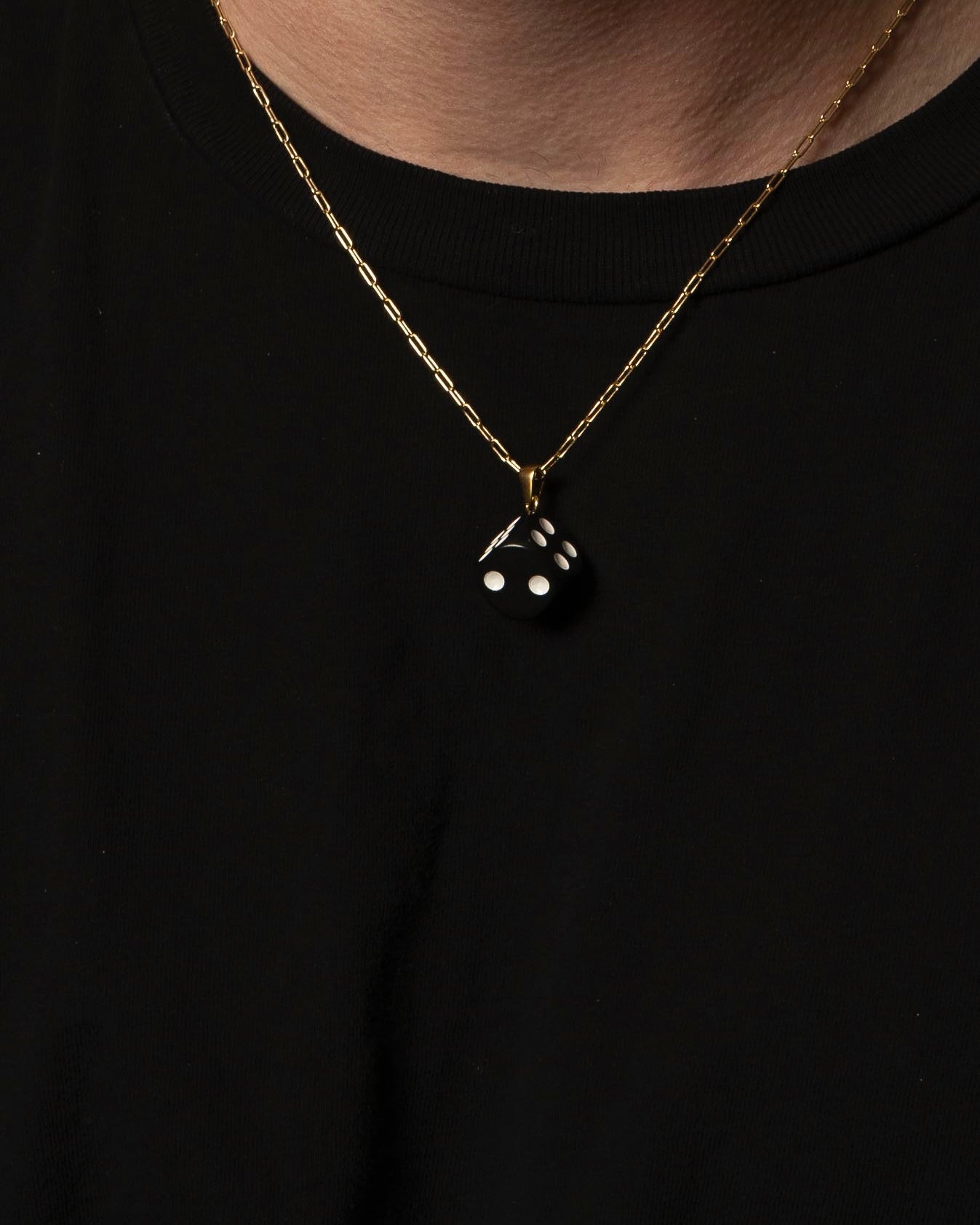 gold necklace with dice 